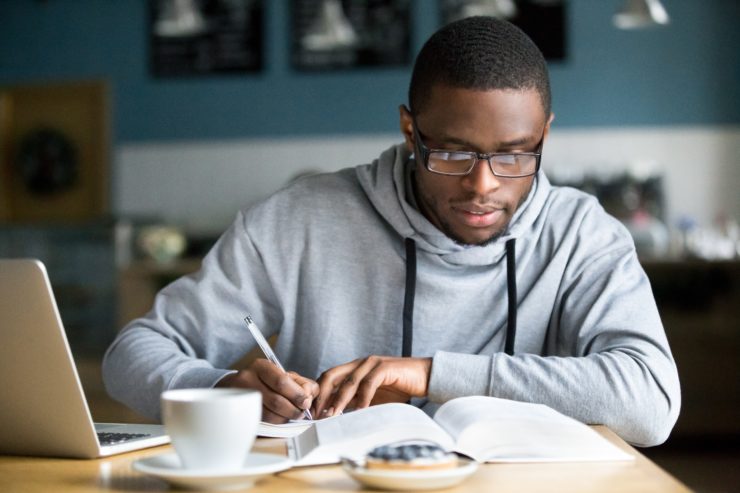 man taking notes at table