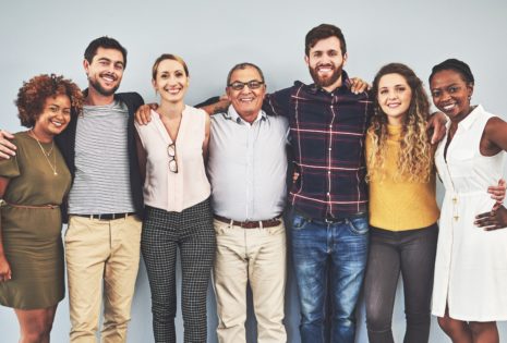 group of people posing with arms around each other