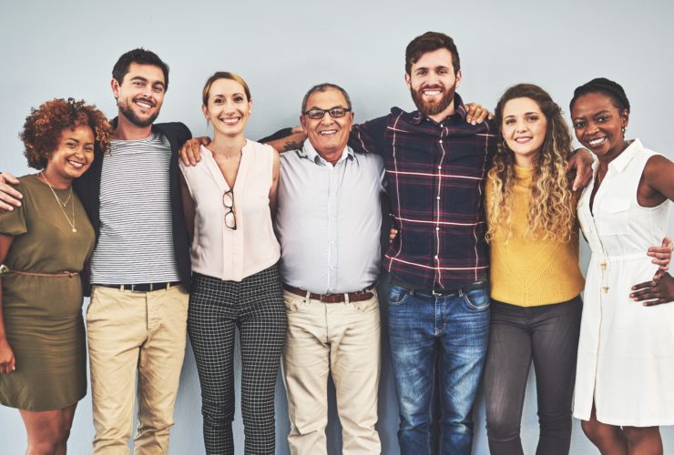 group of people posing with arms around each other