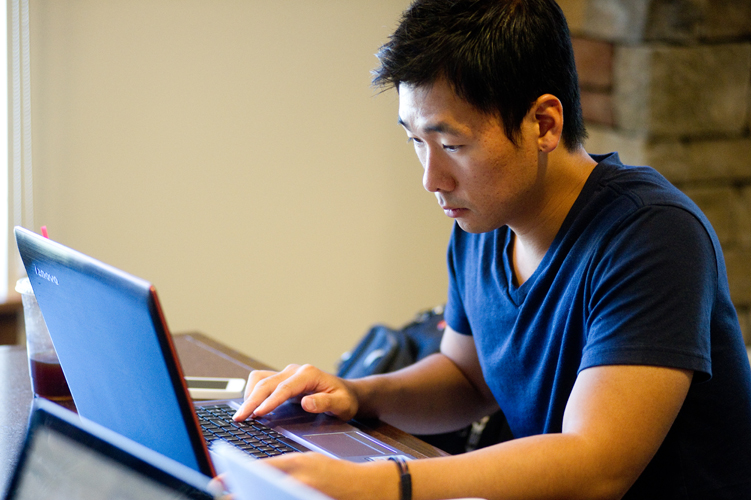 man looking at computer inside