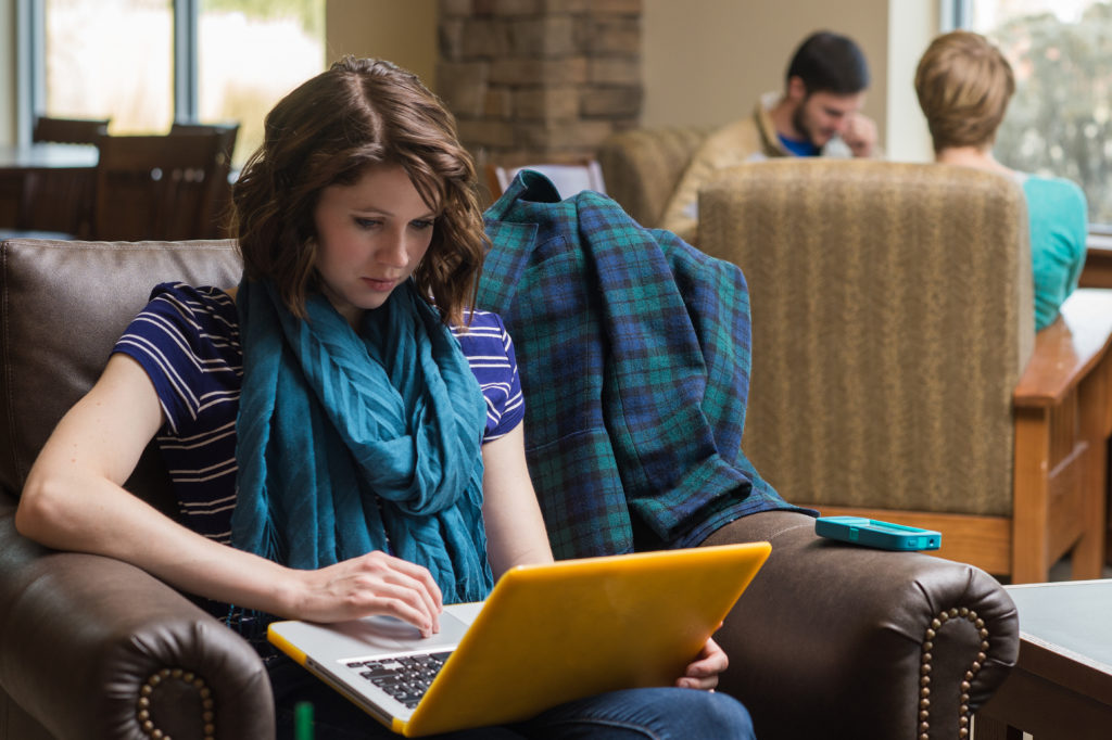 woman on laptop in chair