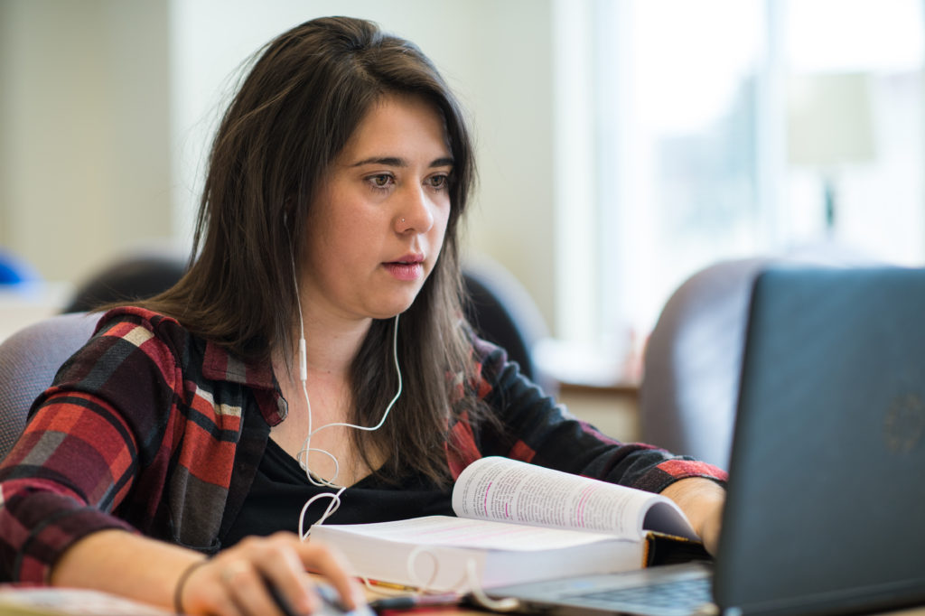 woman on laptop with headphones in