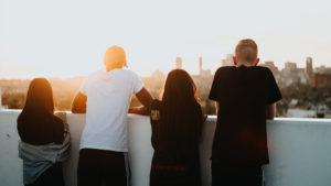 four people looking onto skyline