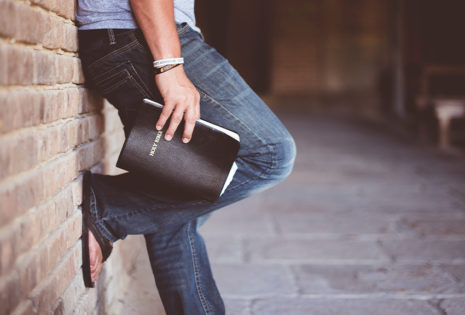 person holding bible waist down view