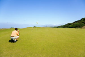 golfer looking onto hole