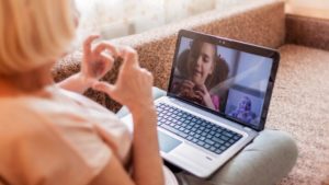 internet video conference with child and woman making hearts