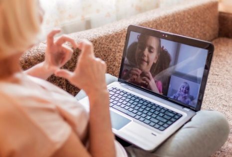 internet video conference with child and woman making hearts