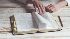 hand turning bible pages