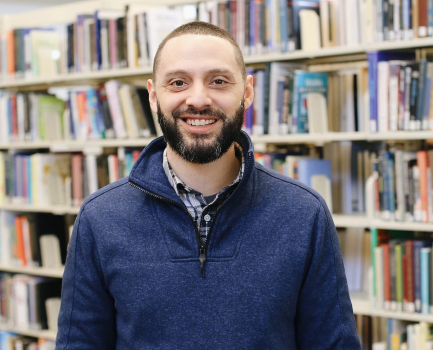 Smiling male Denver Seminary student with beard looking directly at camera