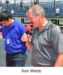 Man praying at a speedway before a car race with microphone in hand