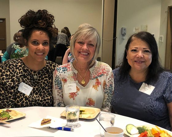 three women at table with food