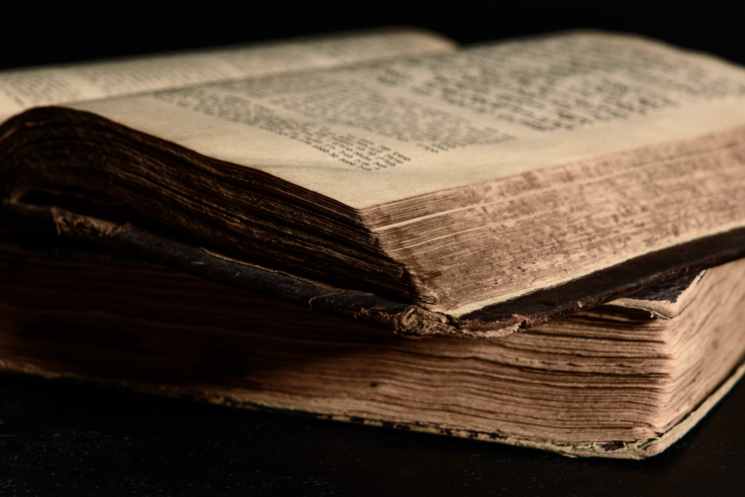 Jewish Bible. Old worn Jewish books. Opened scripture pages. Selective focus. Closeup