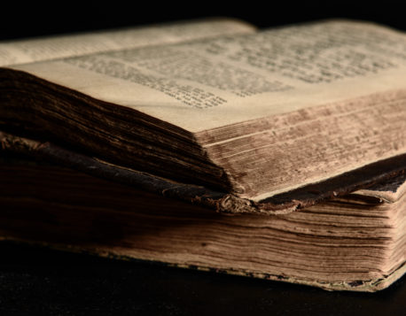Jewish Bible. Old worn Jewish books. Opened scripture pages. Selective focus. Closeup
