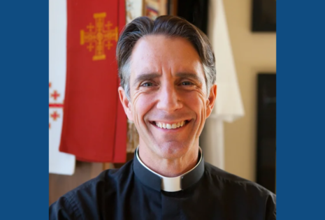 close up picture of smiling man in priest clothes, Reverend Matt Canlis